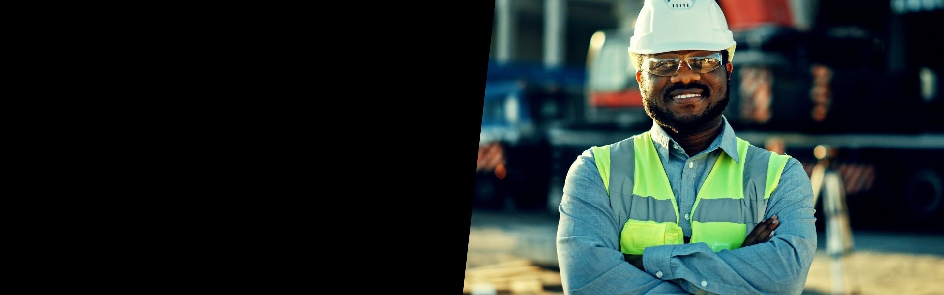 Male construction worker on the job site with hard hat and safety vest